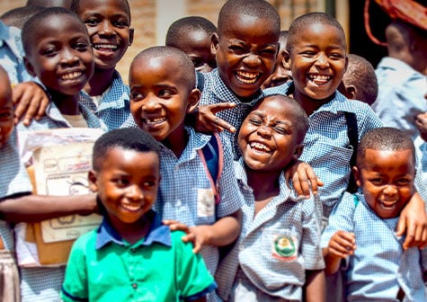 Group of young school children in Ghana smiling